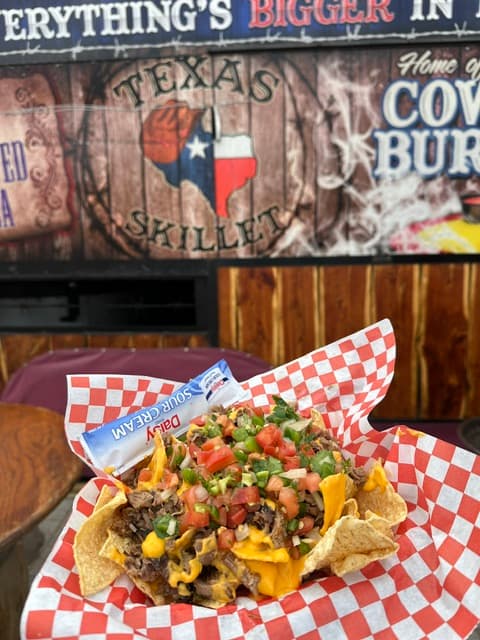 Cowboy brisket nachos loaded on a skillet