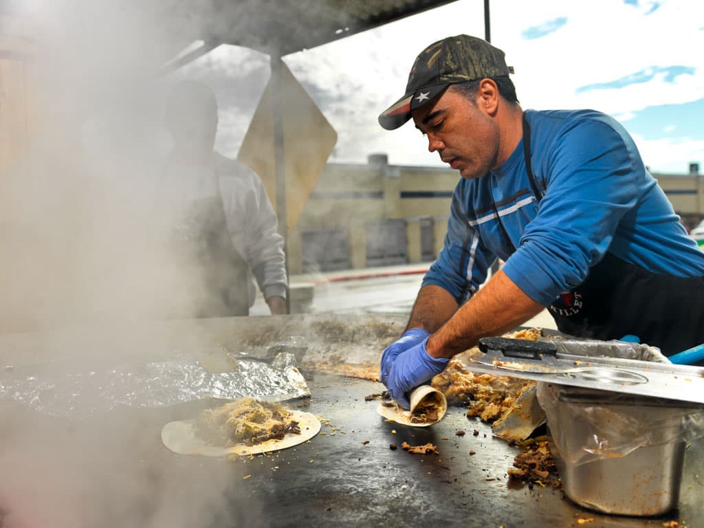 Texas Skillet team member preparing a Cowboy burrito on the griddle